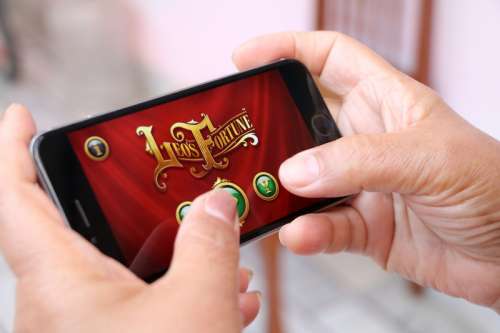 Person playing app on mobile phone free photo
