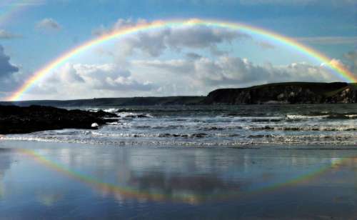 Rainbow and Rainbow Reflection over a large lake free photo