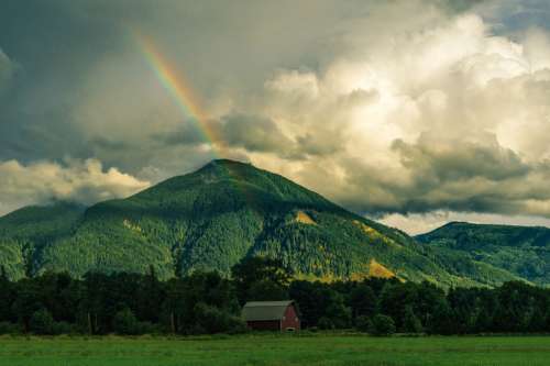 Rainbow behind the Mountain landscape free photo