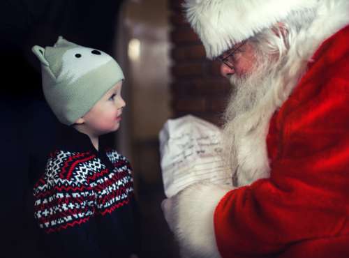 Santa talking with a young child free photo