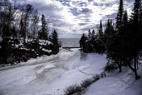 Scenery of the Temperance River flowing into lake Superior in ice and snow in Minnesota free photo