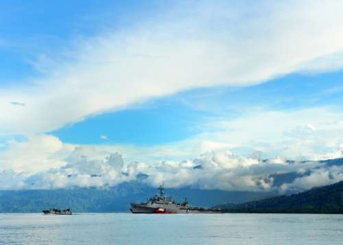 Sea and landscape off the coast in Papa New Guinea with US Transport ship free photo