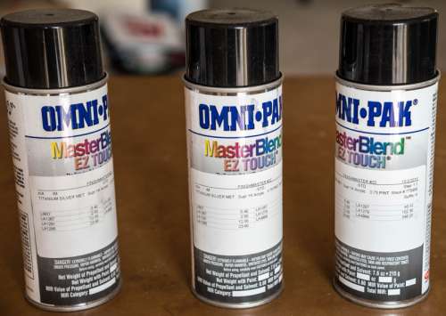 Three spray paint cans free photo