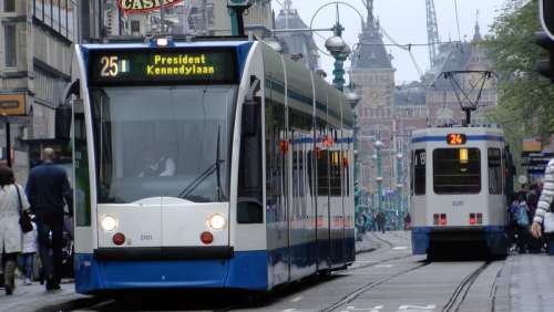 Tram on Damrak in Amsterdam, Netherlands free photo