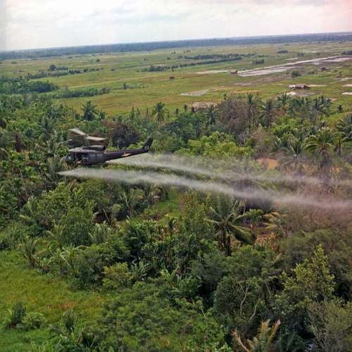 U.S. helicopter spraying chemical defoliants in the Mekong Delta during the Vietnam War free photo