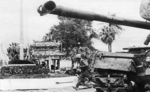 U.S. Marines advance past an M48 Patton tank during the battle for Huế during Vietnam War free photo