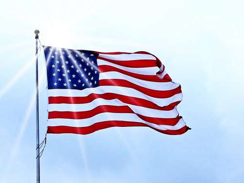 USA Flag fluttering under the sun in the wind free photo