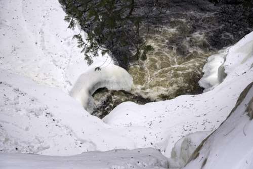 View of the waterfall hole in the winter from above at Cascade River State Park, Minnesota free photo