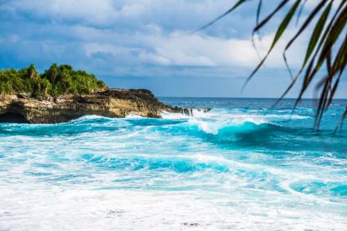 Waves on the ocean crashing on shore in Indonesia free photo