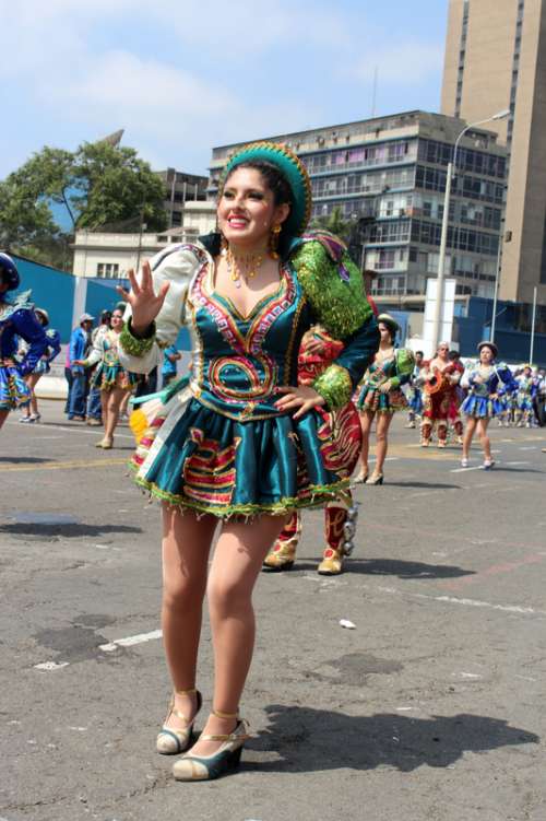 Woman in festival costume dancing in Lima, Peru free photo