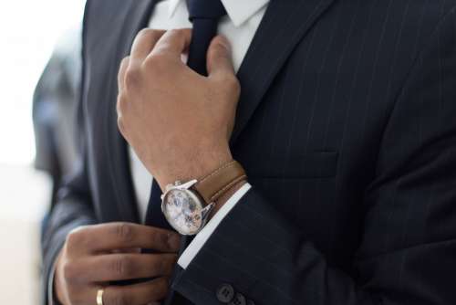 businessman with suit adjusting his tie free image