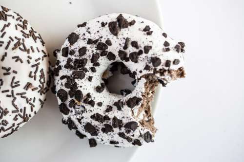 Bitten cookies donut on white bowl