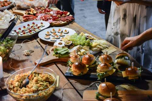 Buffet with burgers, salad, meat, grapes and other foods.jpg
