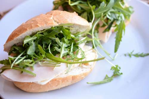 Fresh baguette with rucola and ham