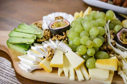 Mix of cheese and vegetables on wood plate