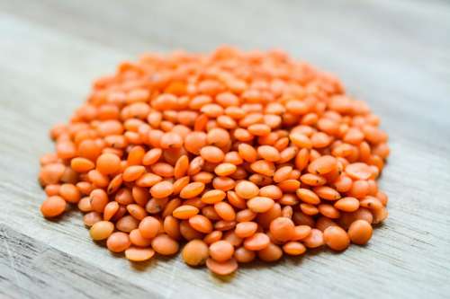 Red lentils on wood