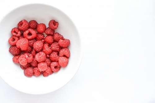 Raspberries in white bowl