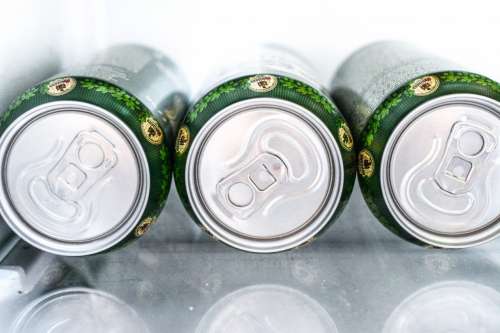 Three cans in a fridge