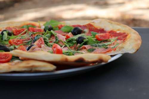 Italian pizza with olives and tomatoes