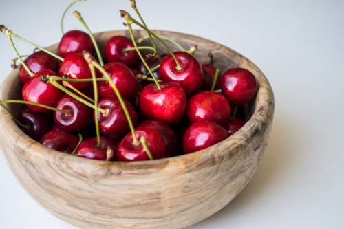 Nice cherries in a wooden bowl