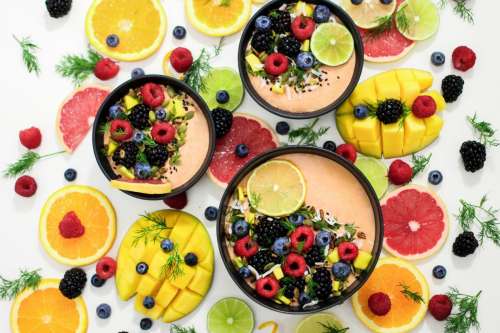 Smoothie bowls with mango, grapefruit and other fruit