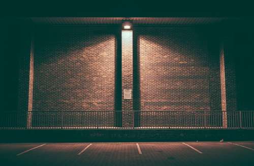 Brick Wall Empty Lighted Night Parking Area