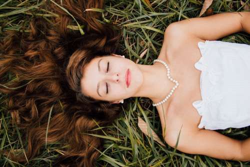 Girl Outdooors Posing Laying In Grass Dream