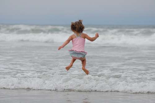 Girl Beach Ocean Waves Jumping Bathing Suit