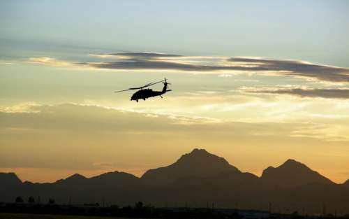 Military Helicopter Flying Dusk Mountains Desert