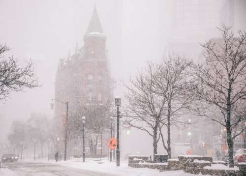 Brick Office Building With Turret In Blizzard Photo