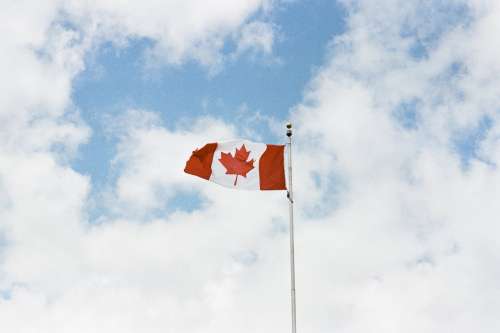 Canadian Flag Against Cloudy Sky Photo