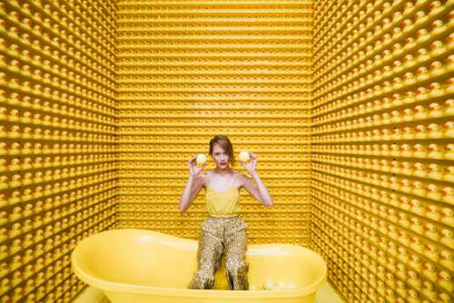 Woman Sits In Tub With Rubber Duckies Photo