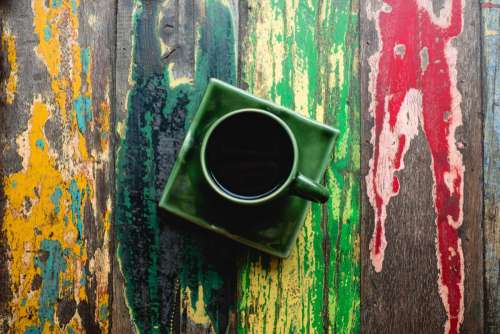 Cup of coffee on a colorful table