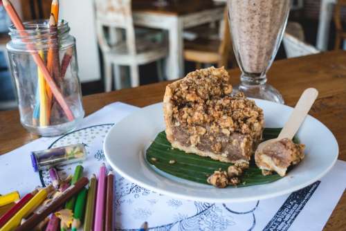 Eating cake while having fun with crayons