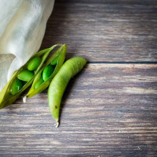 Fresh peas on a wooden background