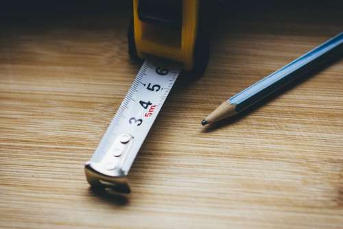 Metal tape measure tool and a pencil
