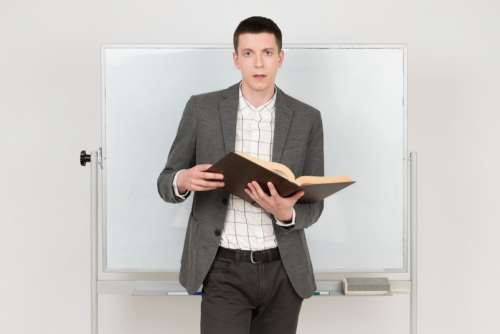 Young Handsome Teacher Holding A Book