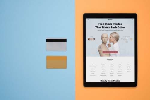 Digital Tablet And Credit Cards Over Contrast Background