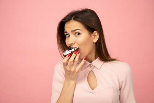 Young Woman Tasting A Cake And Getting Caught