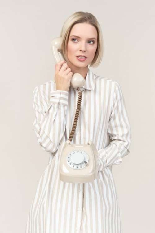 Young Woman Talking On The Old Rotary Phone