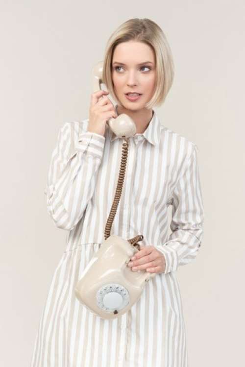 Young Woman Talking On The Old Rotary Phone
