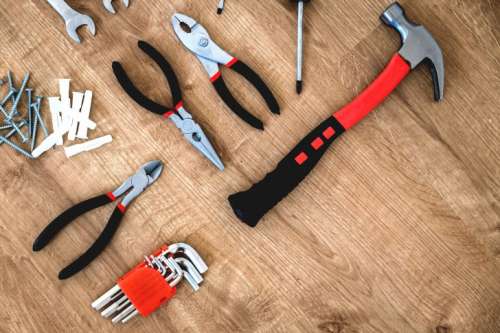Construction tools on the wooden background.