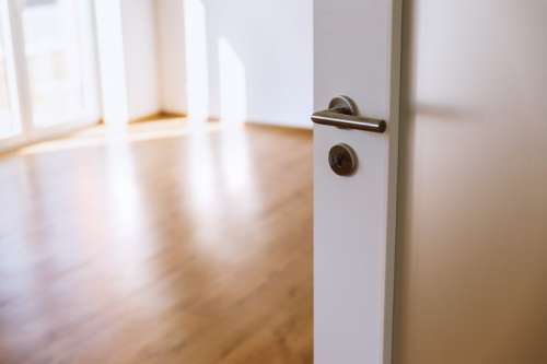 Opened white interior door to new home