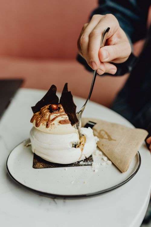 Coffee and cake with meringue in a patisserie