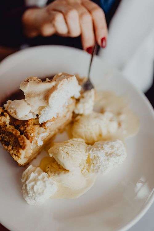 Apple pie with whipped cream and ice cream in Cafe Verte