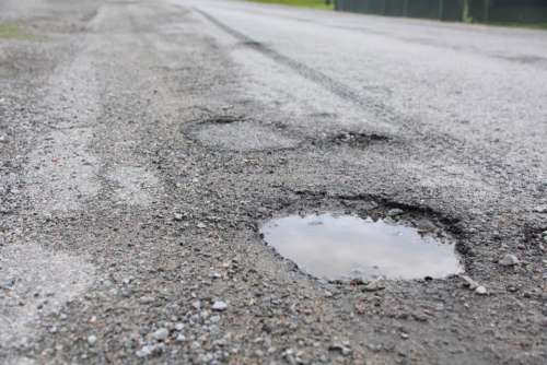 road street pothole chuckhole damaged