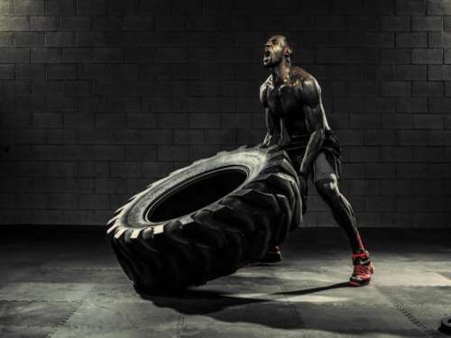 Weightlifting tire man muscles