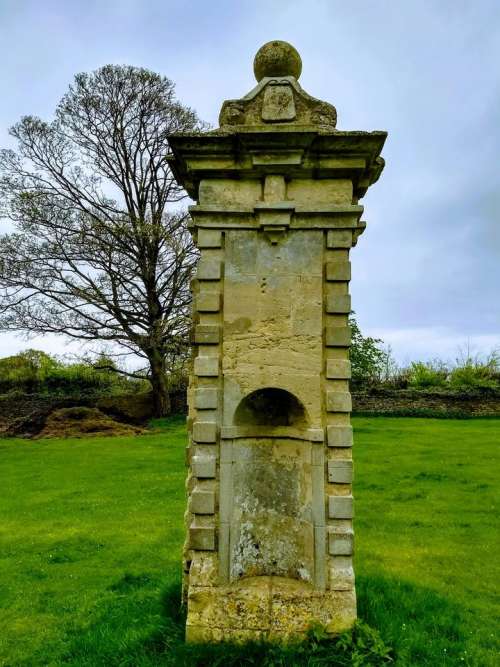 gate post ruin field ancient manor