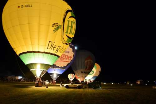 Hot air balloon preparation inflation start night glow