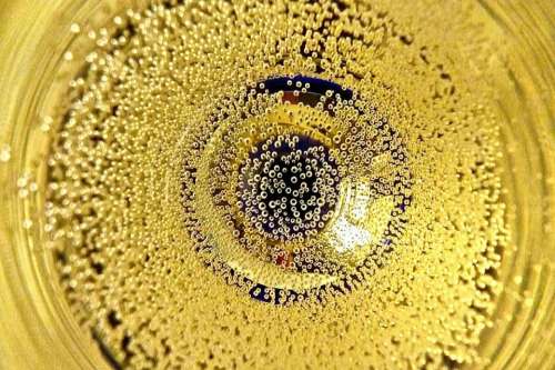 Prosecco bubbles yellow glass circle